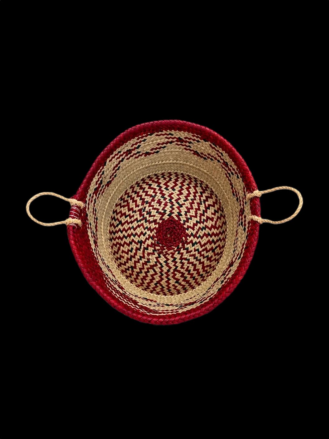 Palm-leaf basket with a maroon rim and zigzag pattern — top view
