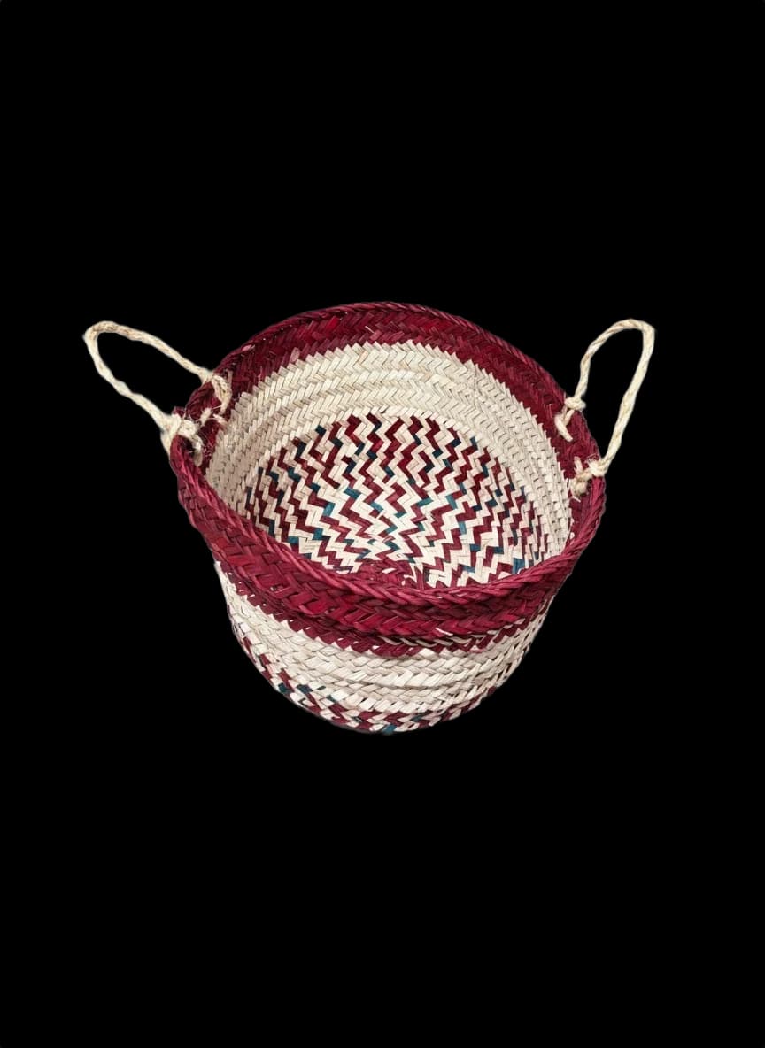 Small palm-leaf basket with a braided maroon rim — top view