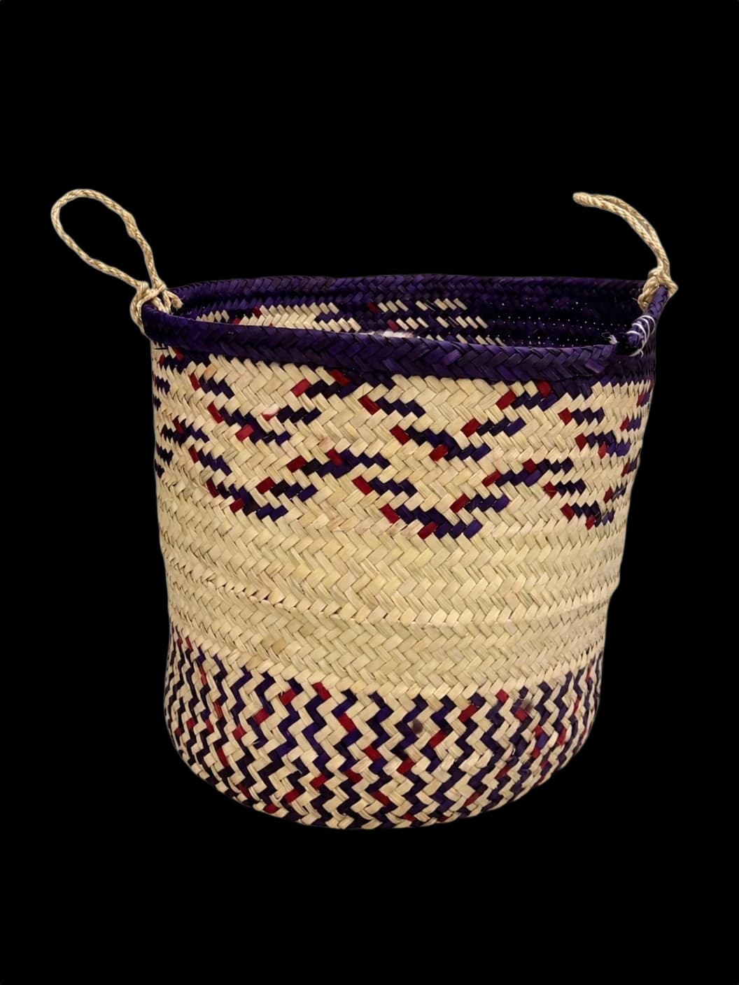 Purple palm-leaf basket with a zigzag pattern and rope handles